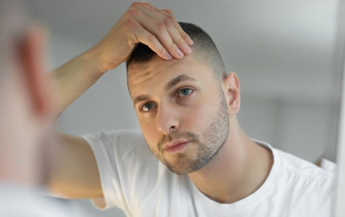 Man checking face in mirror