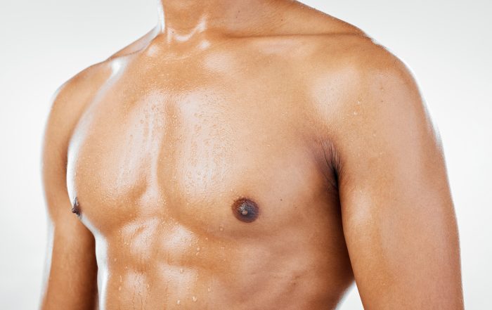 fitness man and chest in studio closeup for healt male breast implant