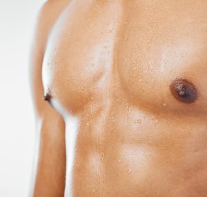 fitness man and chest in studio closeup for healt male breast implant