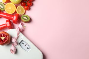 Weight loss or healthy lifestyle accessories on pink background