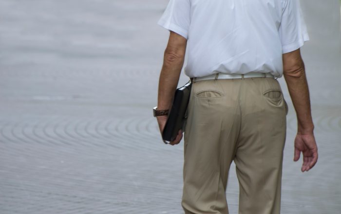 adult male walking down the street with folder in 2022 11 15 23 17 23 utc