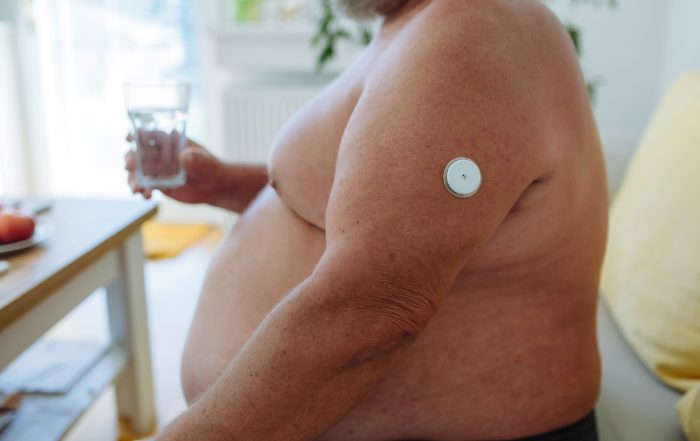 Diabetic man drinking water to better manage his diabetes.