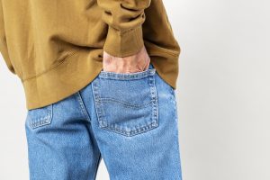 Man put his hand into back pocket of jeans