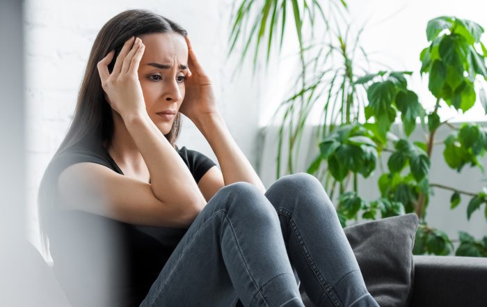 panoramic shot of upset young woman suffering from depression at home