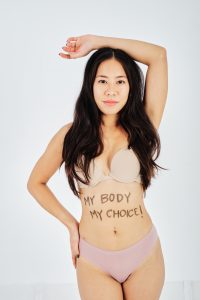 Undressed woman with My Body My Choice written on belly