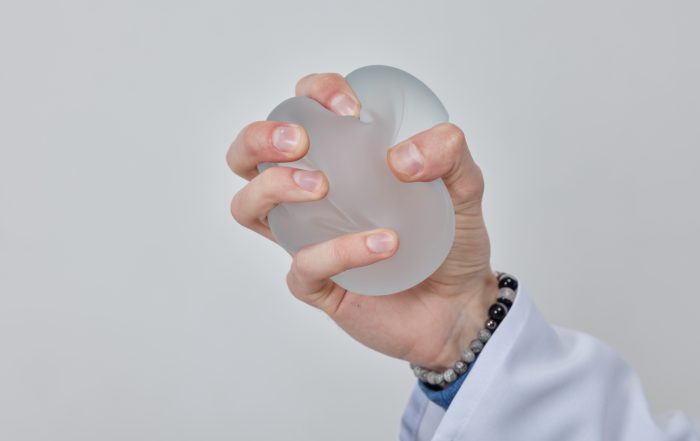 Professional plastic surgeon showing quality of silicone breast implant, mastopexy concept, BREAST LIFT