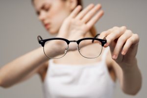 woman glasses in the hands of astigmatism studio treatment