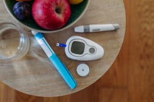 Close up of diabetes supplies and devices on table.